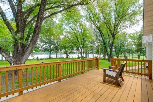 a wooden deck with a bench and a tree at 7 and Acre Private Waterfront Gem in Colonial Beach in Colonial Beach