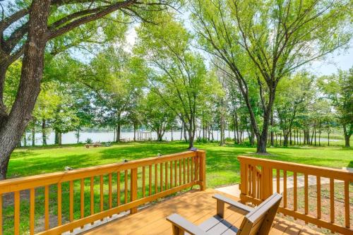 a deck with two chairs and a view of a park at 7 and Acre Private Waterfront Gem in Colonial Beach in Colonial Beach