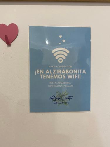 a sign hanging on a wall with a heart at ALZIRA BONITA APARTAMENTO CON TERRAZA Y JACUZZi EXTERIOR in Alzira