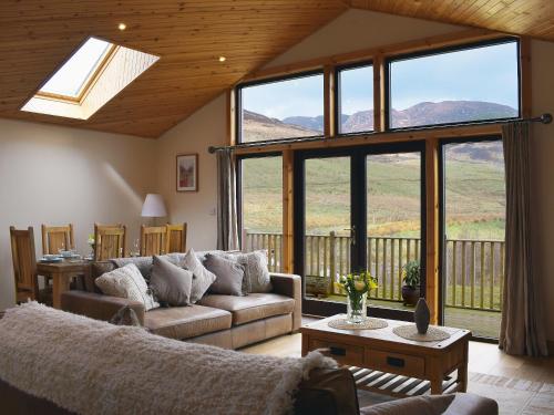 a living room with a couch and a large window at Frith View in White Bridge