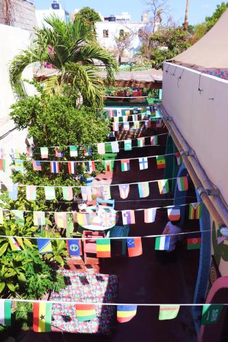 a bunch of flags are hanging on a building at Sunset Hostel - Centro - in La Paz