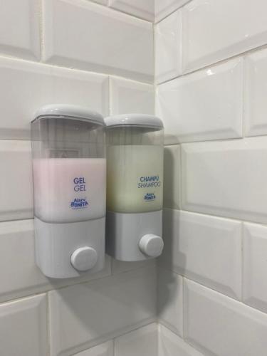 a wall with two containers of candles on it at ALZIRA BONITA APARTAMENTO CON DOS HABITACIONES CON VISTAS AL RiO JUCAR in Alzira
