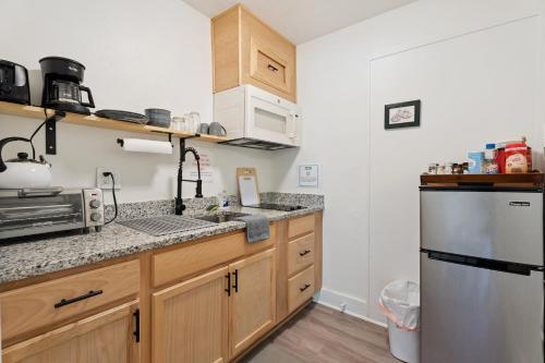 a kitchen with a sink and a counter top at Uptown Okc Studio Paseo Arts & Bricktown #22a in Oklahoma City