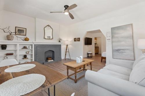 a living room with a white couch and a table at Uptown Okc Studio Paseo Arts & Bricktown #22a in Oklahoma City