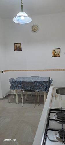 a kitchen with a table and chairs in a room at An&Gy house in Tursi