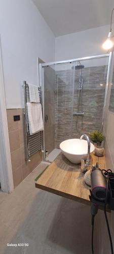 a bathroom with a white sink and a shower at An&Gy house in Tursi