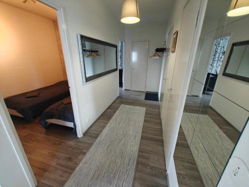 a hallway of a house with a bed and a mirror at Pyry in Kangasala