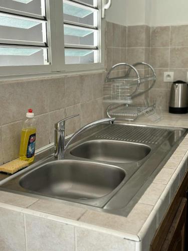 a stainless steel kitchen sink in a kitchen at Expédit Horizon in Salazie