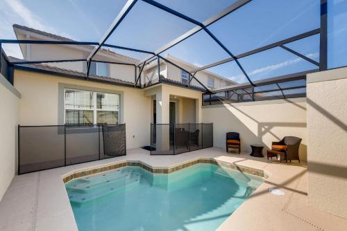 a swimming pool in the middle of a house at 4825 LL - Storey Lake in Kissimmee