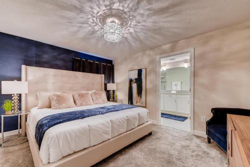 a bedroom with a large bed with a blue accent wall at 4825 LL - Storey Lake in Kissimmee
