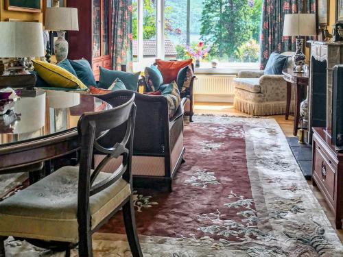 a living room with a couch and a table at An T'abhall in Glencripesdale