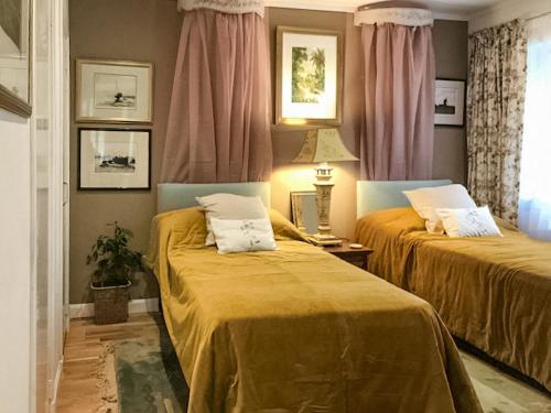 two beds sitting next to each other in a room at An T'abhall in Glencripesdale