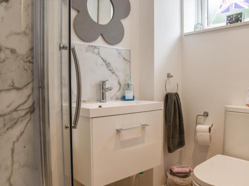 a bathroom with a sink and a toilet at Sunnyside in West Mersea