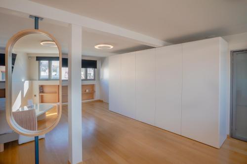 a room with a mirror and a white wall at Apeiron Athena Residences in Athens