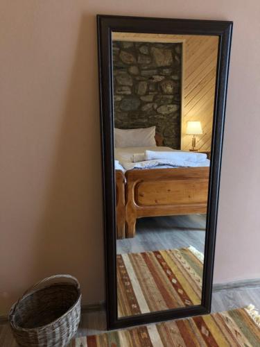 a mirror in a room with a bed and a bed sqor at Guest House Keti Margiani Mestia in Mestia