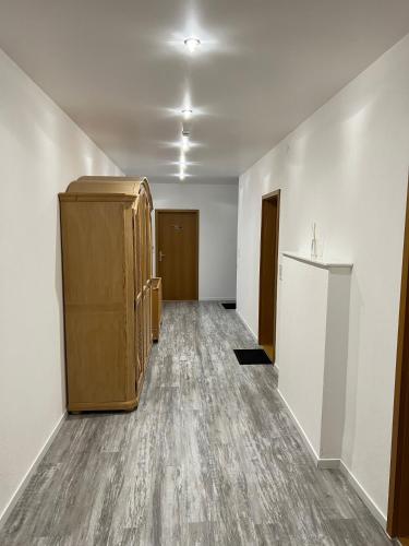 an empty room with a large wooden cabinet in it at Gasthof Löwen in Pfronten