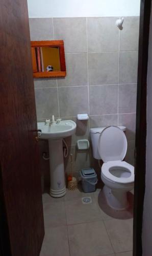 a bathroom with a toilet and a sink at Cabañas virgen de la candelaria in Maimará