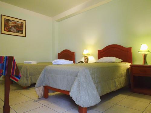 Postel nebo postele na pokoji v ubytování Libon's Hotel