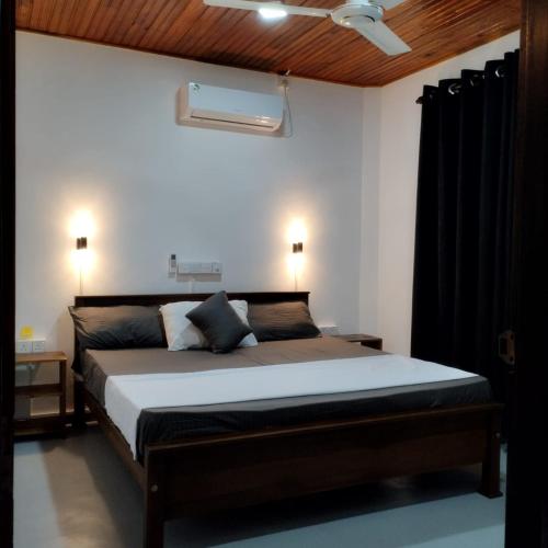 a bedroom with a large bed in a room at Villa Aroma Ahangama in Ahangama