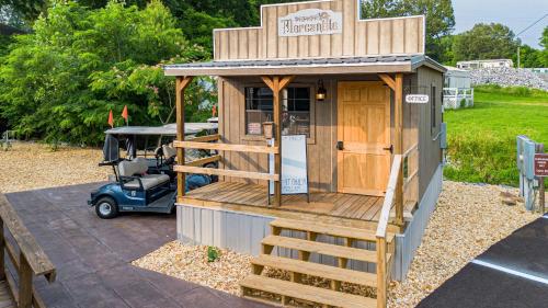 a small wooden building with a staircase leading to it at The Outpost in Grand Rivers