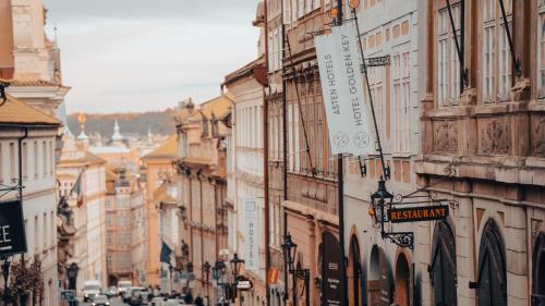 a busy city street with buildings and cars on the road at Hotel Golden Key Prague Castle in Prague