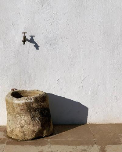 a shadow of a fire hydrant on a white wall at Masseria Caposella in Ugento