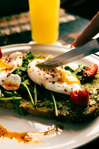 a plate of food with eggs on top of toast at Esplendor by Wyndham Los Mochis Country Place in Los Mochis