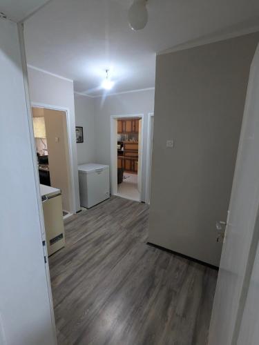 an empty living room with a kitchen and a hallway at Gordana in Senjski Rudnik