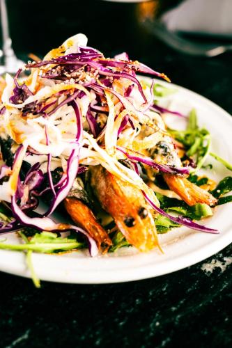 a plate of food with a salad on a table at Esplendor by Wyndham Los Mochis Country Place in Los Mochis
