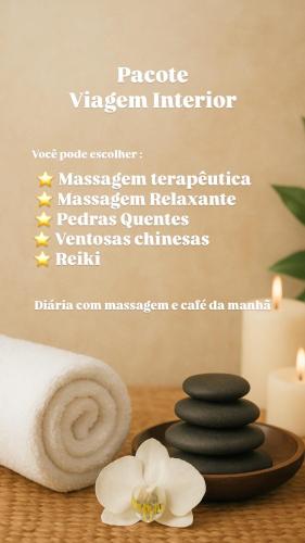 a poster of massage equipment with a white flower and towels at Casa Estelar in Cabo Frio
