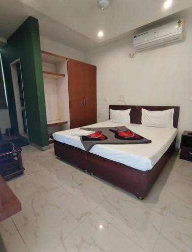 a bedroom with a large bed in a room at Hotel Green Land in Mohali