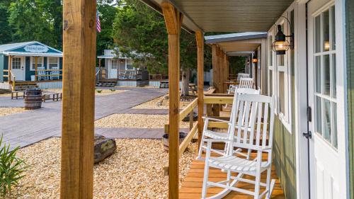 a porch with chairs and a table on a house at The Outpost in Grand Rivers
