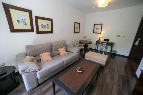 a living room with a couch and a table at Villa Turistica de Bubion in Bubión