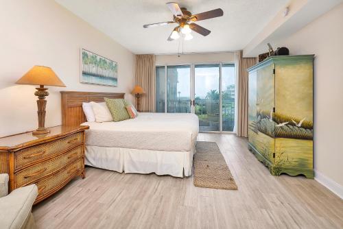 a bedroom with a bed and a ceiling fan at St. Simons Grand #120 in Saint Simons Island