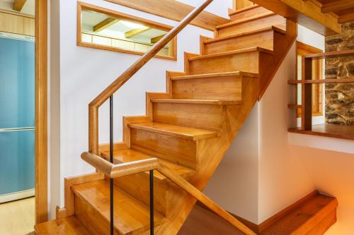 a wooden staircase in a house with wooden floors at Apartamentos Campanas de San Juan in Santiago de Compostela