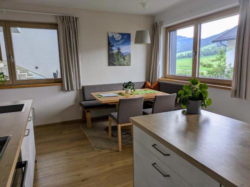 a kitchen and living room with a table and a couch at Ferienwohnung Bergzauber in Sankt Jakob in Haus