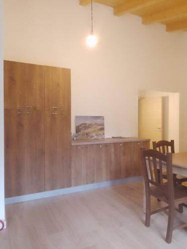 a dining room with a table and a wooden wall at Orsera in Cesiomaggiore