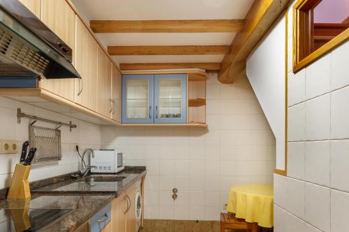 uma cozinha com um lavatório e uma bancada em Apartamentos Campanas de San Juan em Santiago de Compostela