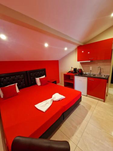 a red bed with a napkin on it in a kitchen at Apartments Vesna Luxury & Stefan ap 4 in Paralia Katerinis