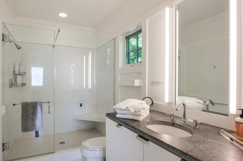 une salle de bain blanche avec un lavabo et une douche dans l'établissement Group-Friendly Newbury Stunner Home Gym, Hot Tub!, à Newbury