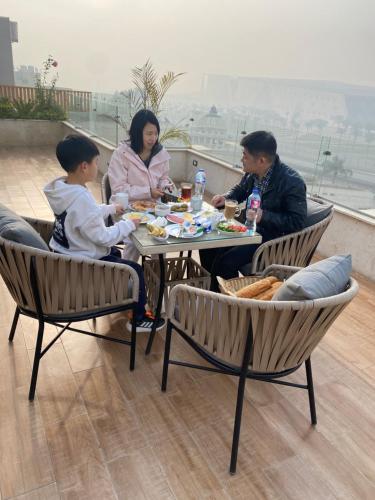 a group of people sitting at a table eating food at GEM view BOUTIQUE in Cairo