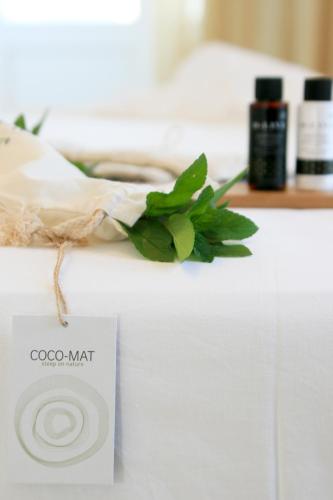 a sign on a counter with a plant on it at Paradissos Hotel in Pera Gyalos