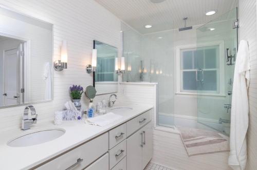 a white bathroom with two sinks and a shower at Walk to Oxford Square, Faulkner house, Ole Miss in Oxford