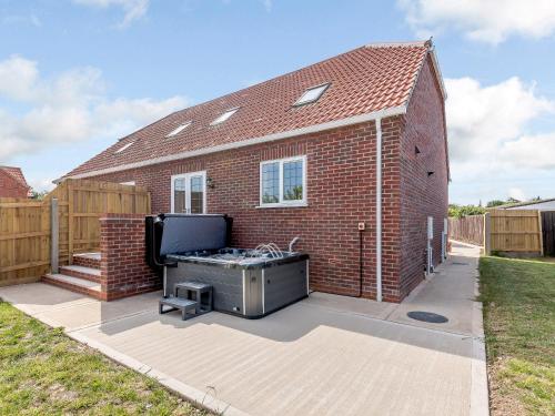 a brick house with a grill in the backyard at Dawson Park 1 - Uk12660 in Mablethorpe