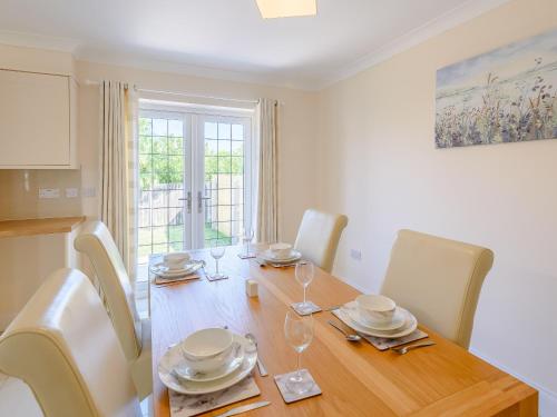 a dining room with a wooden table and chairs at Dawson Park 1 - Uk12660 in Mablethorpe