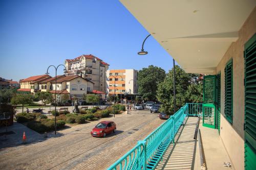 a red car parked on a balcony of a building at Greco Boutique Hotel in Shkodër