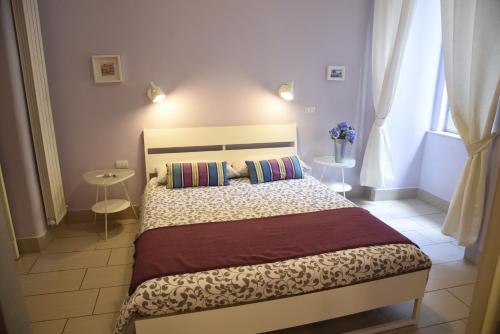 a bedroom with a large bed in a room at Cerasella B&B in Naples