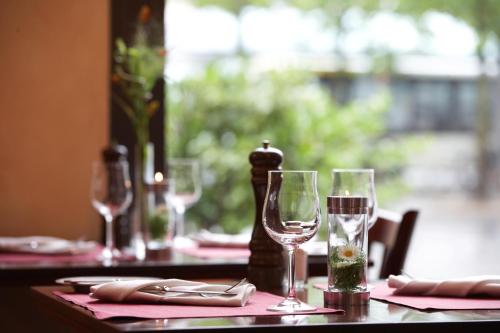 a table with wine glasses and napkins on it at IntercityHotel Bremen in Bremen