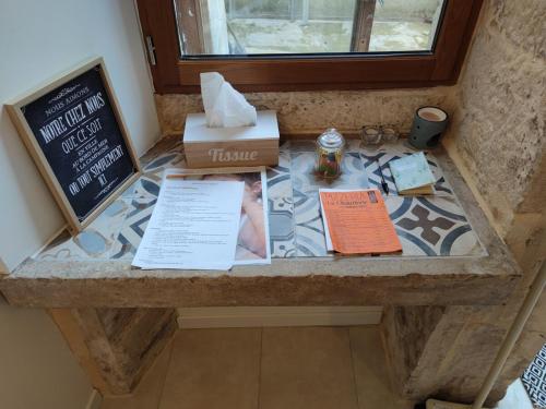 a counter with some boxes and papers on it at Studio de charme, au calme dans le vieux Chaumont in Chaumont