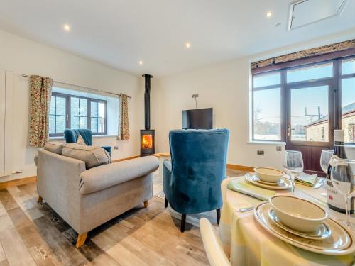 a living room with a table and a chair at Ty Gwair - Uk41512 in Llanfair Clydogau